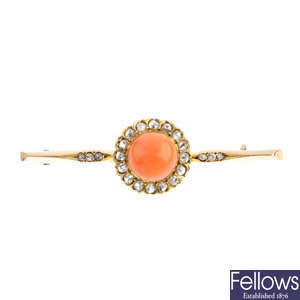 An early 20th century gold, coral and diamond bar brooch.