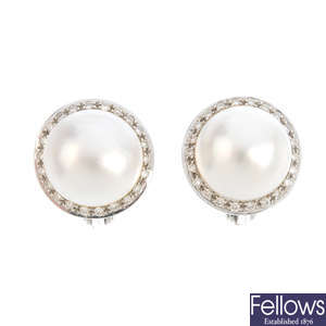 A pair of diamond and mabe pearl earrings.
