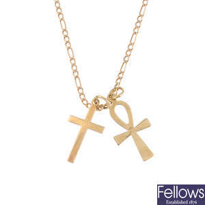 A 9ct gold chain with two 9ct gold cross pendants.