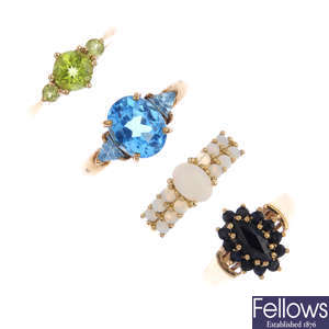 Four gem-set dress rings.