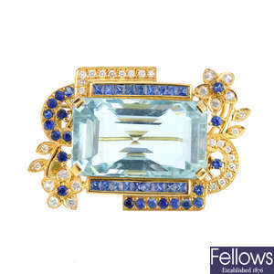 An aquamarine and gem-set brooch.