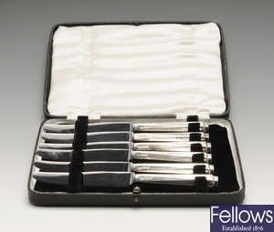 A cased set of silver-handled tea knives, a silver napkin ring, assorted silver spoons, sugar tongs & a small quantity of plated flatware.