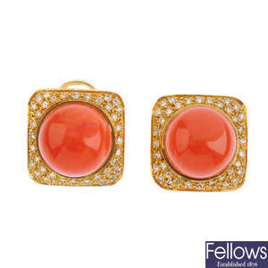 A pair of coral and diamond earrings.