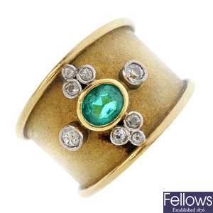 An 18ct gold emerald and diamond band ring.