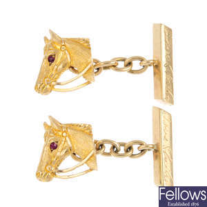 A pair of mid 20th century 9ct gold ruby horse cufflinks.