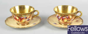 A pair of Royal Worcester porcelain fruit-painted tea cups and saucers by Roberts.