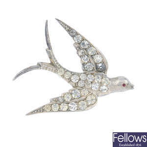 An early 20th century silver paste swallow brooch, a charm bracelet, locket and selection of marcasite jewellery.