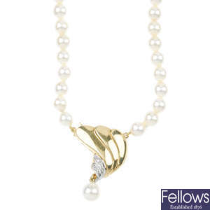 A cultured pearl necklace with diamond-set clasp.