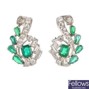 A pair of diamond and emerald earrings.