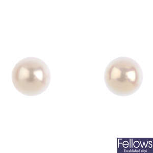 A pair of cultured pearl stud earrings, a bracelet and a ring mount.