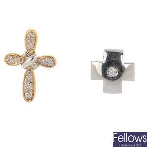 Two diamond cross pendants.