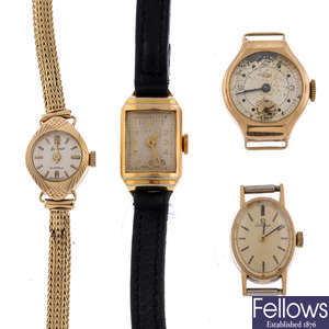 A group of four assorted watches and watch heads.