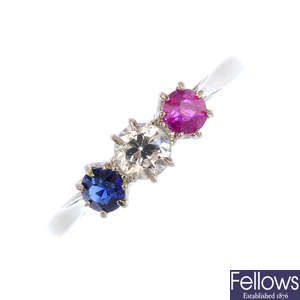 A diamond, sapphire and ruby three-stone ring.