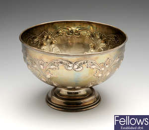 An Edwardian silver rose bowl with embossed decoration.