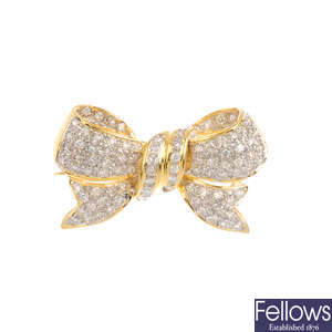 A diamond bow brooch.