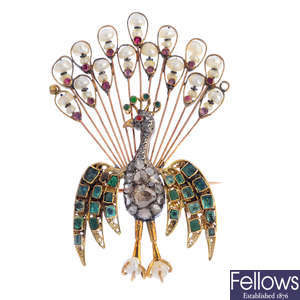 An early 20th century diamond, emerald, ruby and seed pearl peacock brooch.