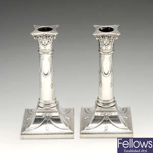 A pair of early twentieth century silver mounted candlesticks