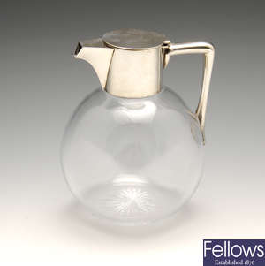 A late Victorian silver mounted clear glass claret jug.