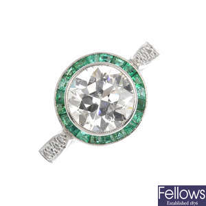 A platinum diamond and emerald cluster ring.