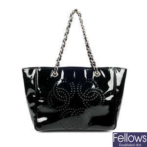 CHANEL - a CC logo perforated patent leather handbag.