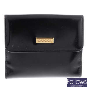 GUCCI - a black patent leather purse.