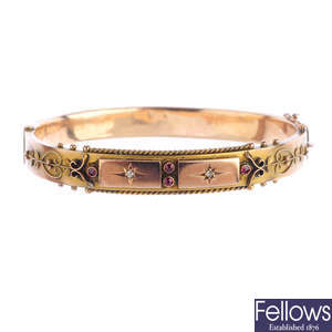 An Edwardian 9ct gold gem-set hinged bangle.