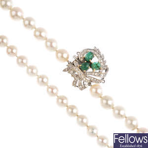 A cultured pearl single-strand necklace, with emerald and diamond clasp.
