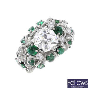 A mid 20th century diamond and emerald dress ring.