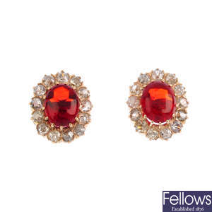 A pair of fire opal and diamond cluster earrings.