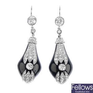 A pair of diamond and onyx earrings.