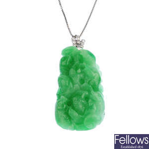 A carved jade and diamond pendant.