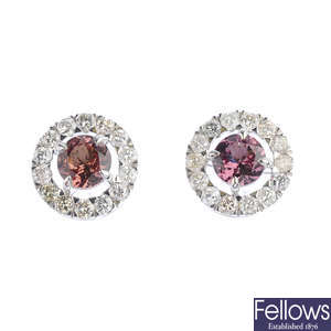 A pair of brown garnet and diamond stud earrings.