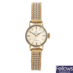 OMEGA - a lady's yellow metal bracelet watch retailed by Turler.