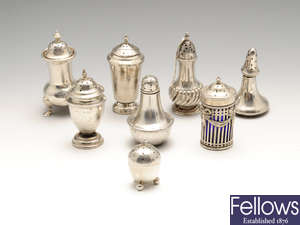 A selection of eight late Victorian & later silver pepper pots, plus a pair of ceramic examples.
