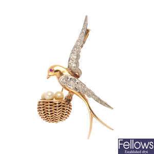 A diamond and gem-set bird brooch.