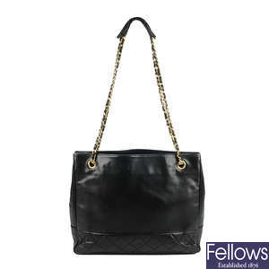 CHANEL - a vintage black lambskin leather partially quilted handbag.