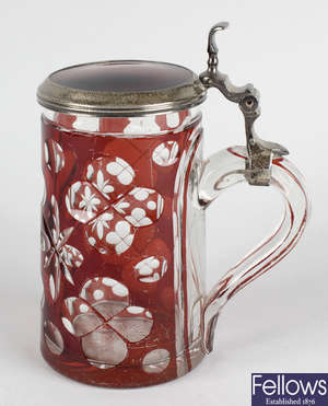 A ruby flashed glass tankard with silver mounted lid.