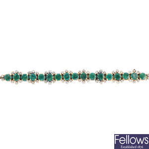 An emerald and diamond bar brooch.
