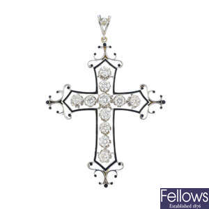 A diamond and enamel cross pendant.