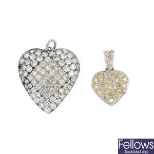 Two diamond heart pendants.