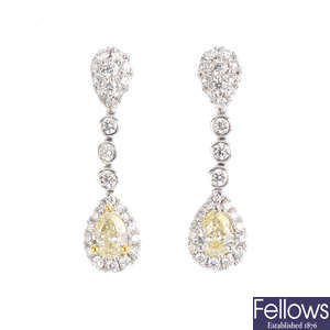 A pair of 18ct gold diamond and 'yellow' diamond earrings.