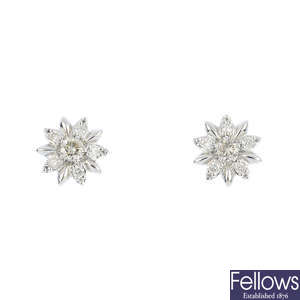 A pair of diamond floral earrings.