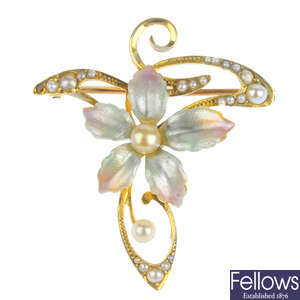 A split pearl and enamel floral brooch.
