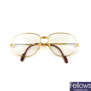 CARTIER - a pair of gold-plated prescription glasses.