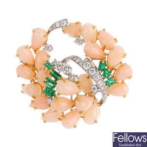 A coral, diamond and emerald brooch.