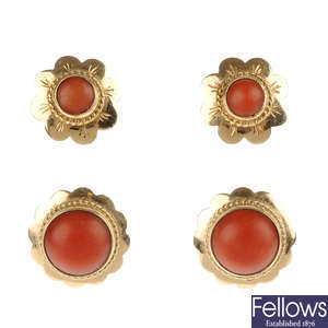 Two pairs of coral ear studs.