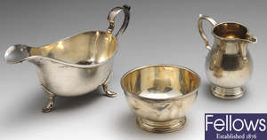 A 1940's silver sauce boat, together with a silver cream jug & sugar bowl. (3).