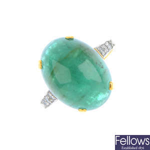 An emerald and diamond single-stone ring.