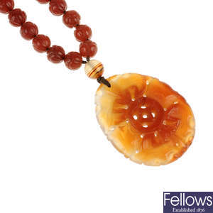 A carved agate pendant and chain.