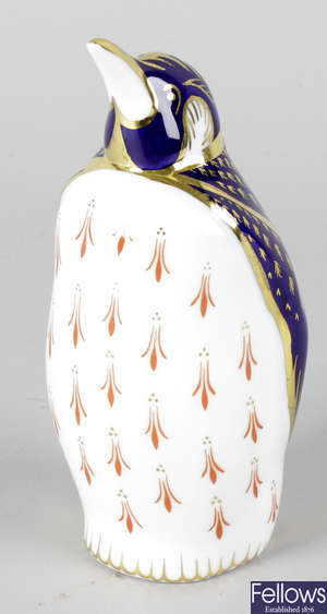 A Royal Crown Derby porcelain paperweight modelled as a penguin.